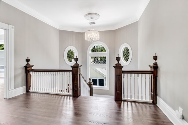 entrance foyer featuring a notable chandelier, dark hardwood / wood-style floors, and crown molding