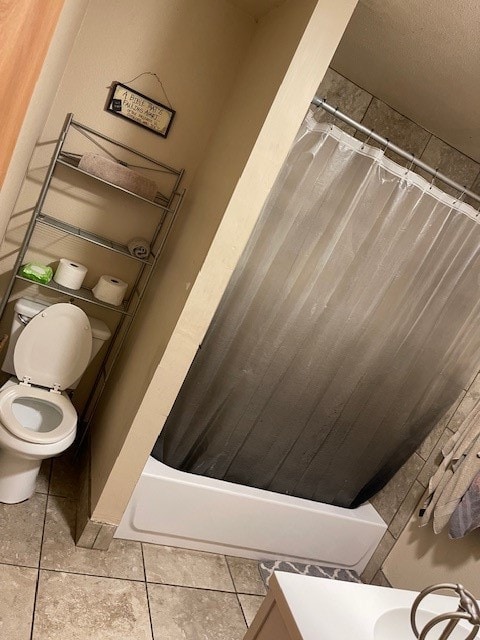 bathroom featuring shower / bath combo, tile patterned flooring, and toilet