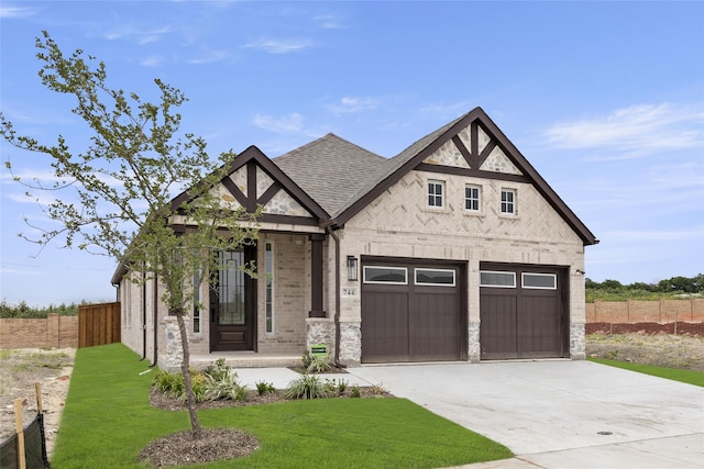 view of front of property with a garage and a front lawn