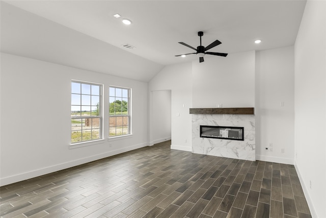 unfurnished living room featuring ceiling fan, lofted ceiling, and a fireplace