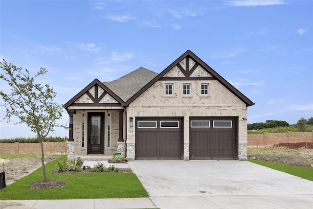 view of front of home featuring a garage and a front lawn