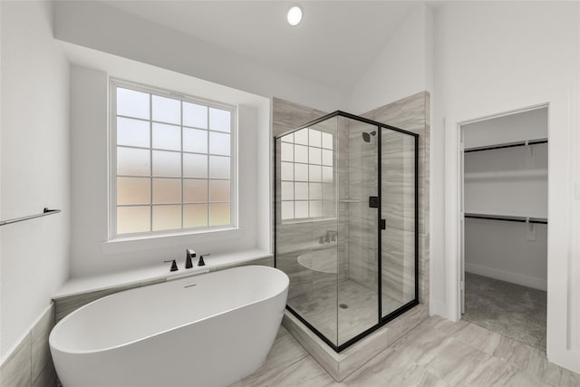 bathroom featuring shower with separate bathtub and lofted ceiling