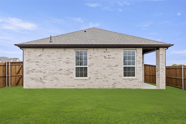 rear view of property with a lawn