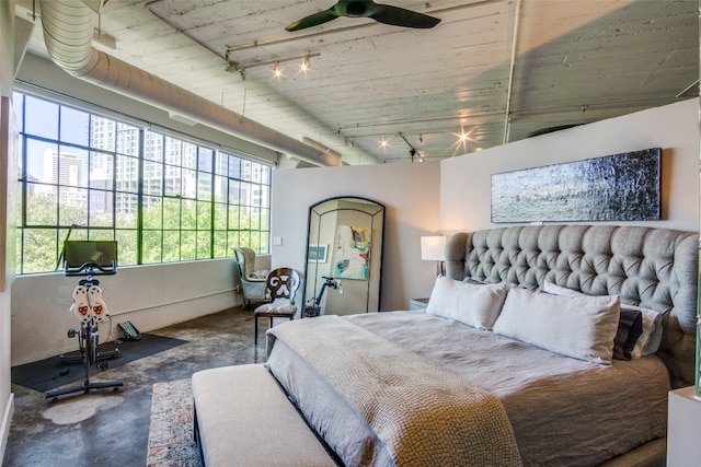 bedroom with rail lighting and ceiling fan