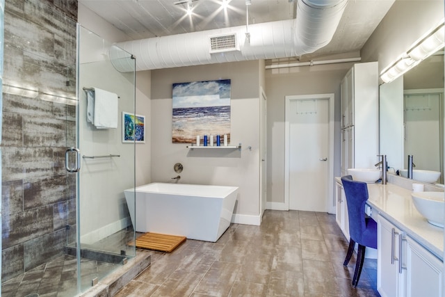 bathroom featuring double sink, walk in shower, tile flooring, and oversized vanity