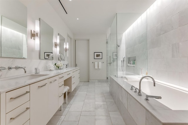 bathroom with tile walls, shower with separate bathtub, tile floors, and dual bowl vanity