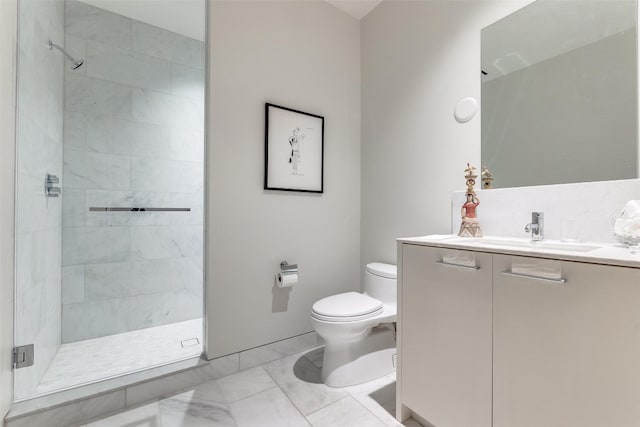 bathroom with tile flooring, tiled shower, toilet, and vanity