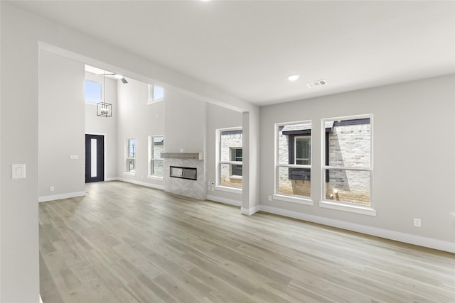 unfurnished living room featuring light hardwood / wood-style floors and a wealth of natural light