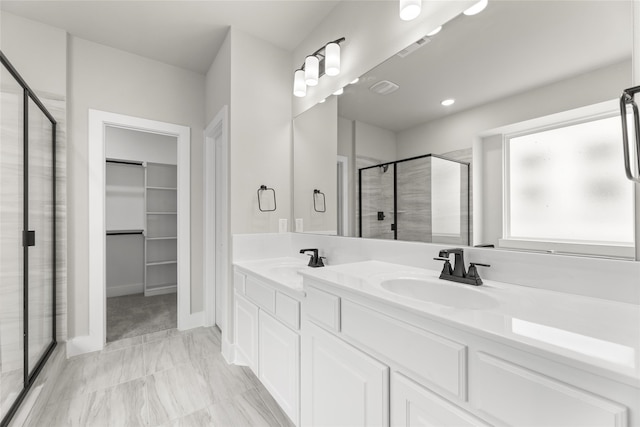 bathroom featuring vanity and a shower with shower door