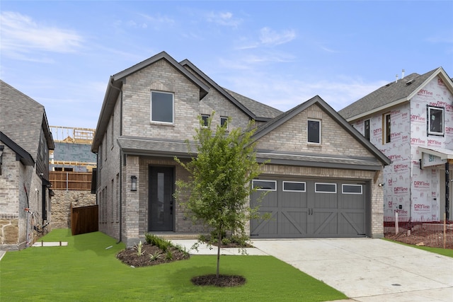 view of front of house featuring a garage and a front yard