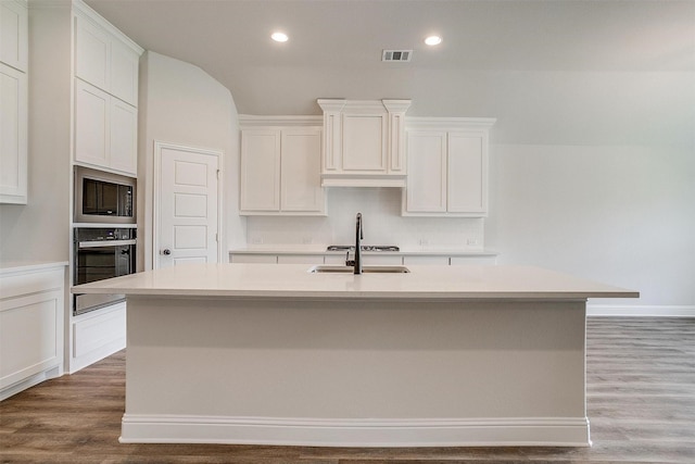 kitchen featuring white cabinetry, a kitchen island with sink, and black appliances