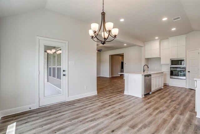 unfurnished dining area featuring vaulted ceiling, wood-type flooring, and a notable chandelier