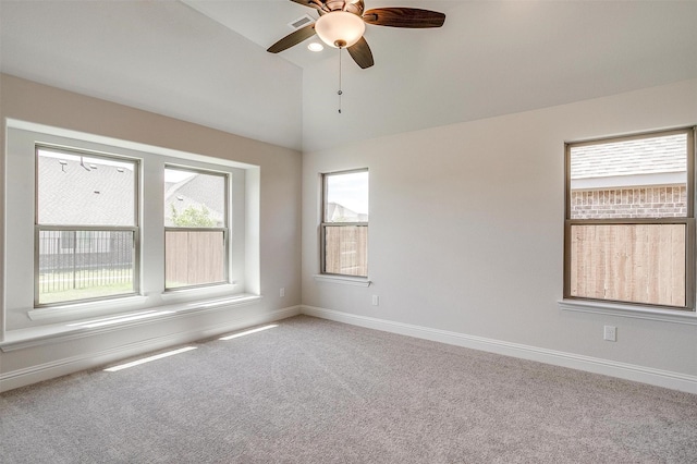 carpeted spare room featuring high vaulted ceiling and ceiling fan