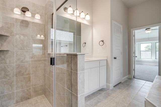 bathroom with ceiling fan, tile patterned floors, walk in shower, and vanity