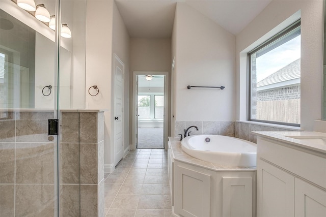 full bathroom featuring tile patterned flooring, vanity, a ceiling fan, a bath, and a stall shower