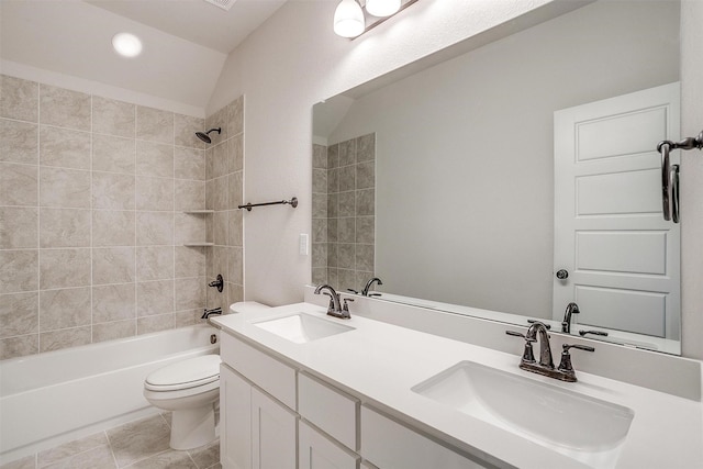 full bathroom with toilet, vanity, vaulted ceiling, tile patterned flooring, and tiled shower / bath combo