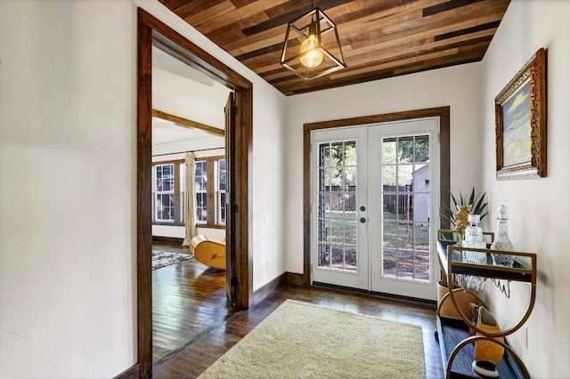 entryway featuring dark wood-type flooring, french doors, and wooden ceiling