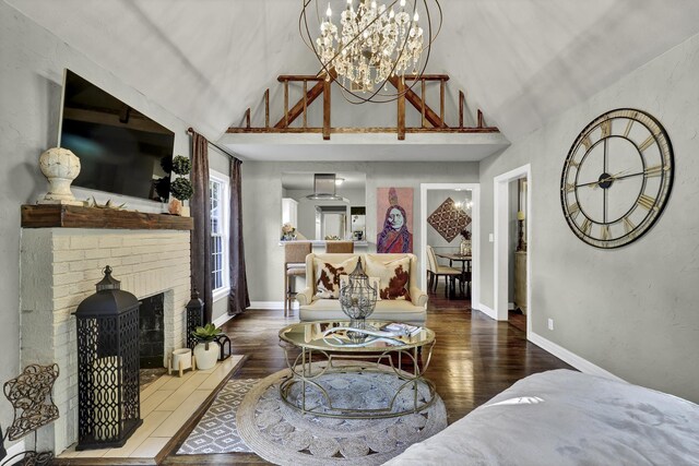 living room with vaulted ceiling with beams, dark wood-type flooring, and an inviting chandelier