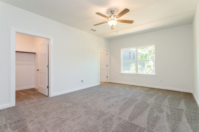 unfurnished room with ceiling fan and carpet flooring