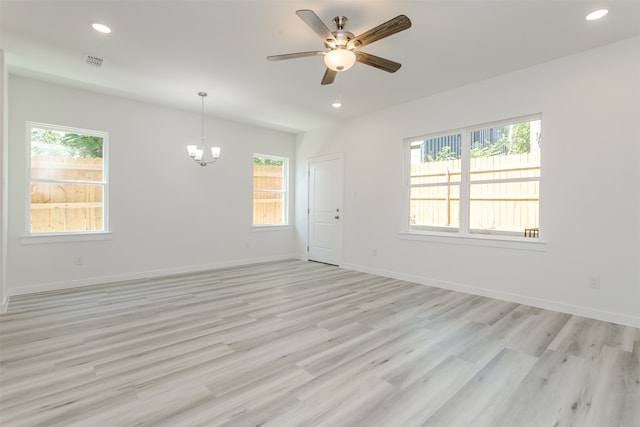 kitchen with stainless steel appliances, hanging light fixtures, a wealth of natural light, and white cabinets