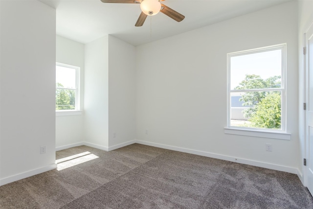 carpeted spare room with ceiling fan and a healthy amount of sunlight