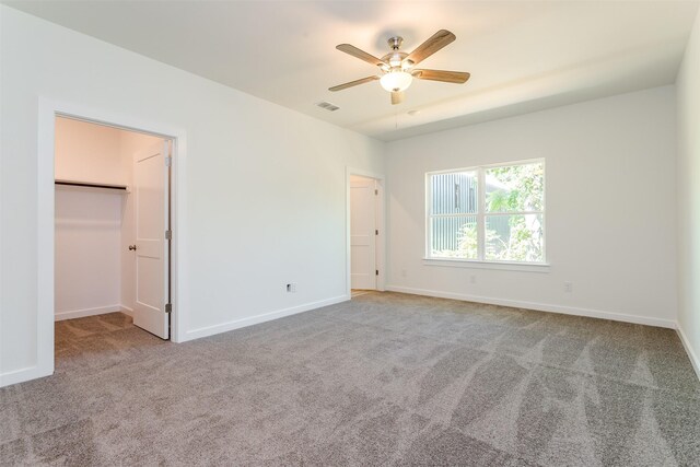 unfurnished bedroom featuring ceiling fan, light colored carpet, and a closet