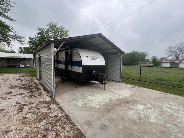 garage featuring a carport and a yard