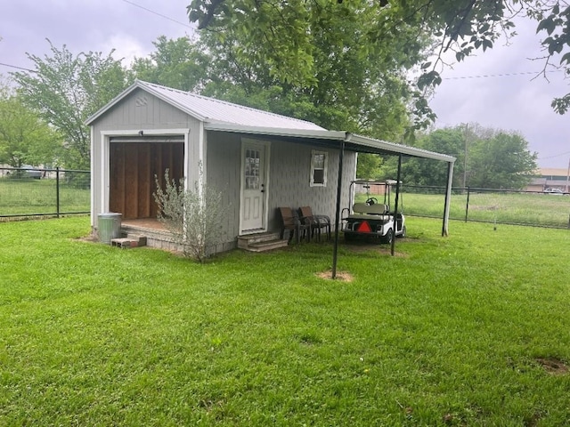 back of property featuring a storage shed and a lawn