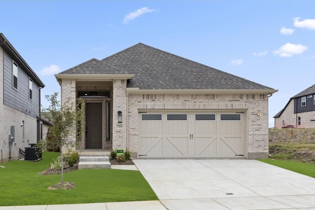 view of front of property with a garage, a front yard, and central air condition unit