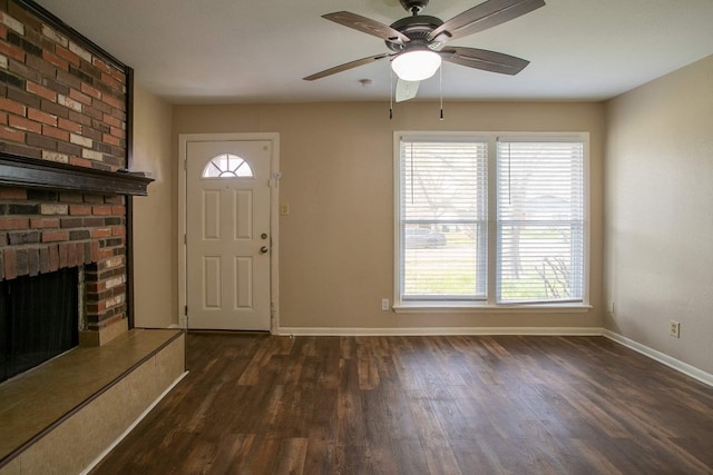 foyer with plenty of natural light, ceiling fan, and a fireplace