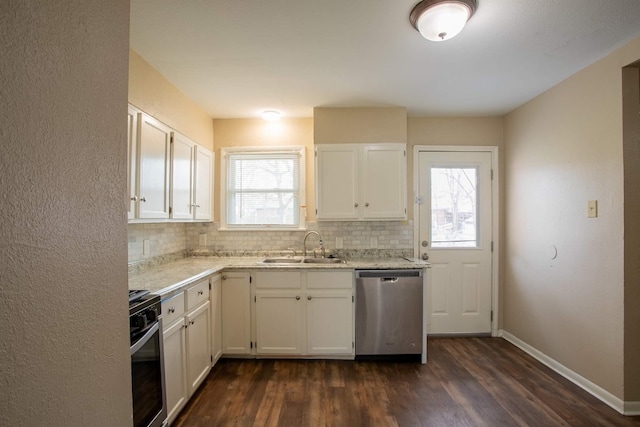 kitchen featuring white cabinets, appliances with stainless steel finishes, a healthy amount of sunlight, and dark hardwood / wood-style flooring