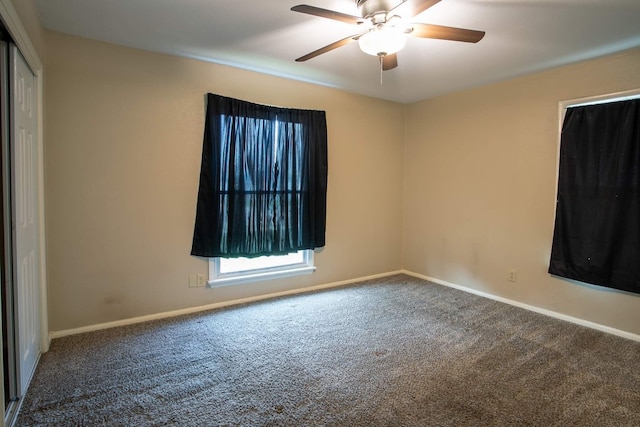 carpeted spare room with ceiling fan