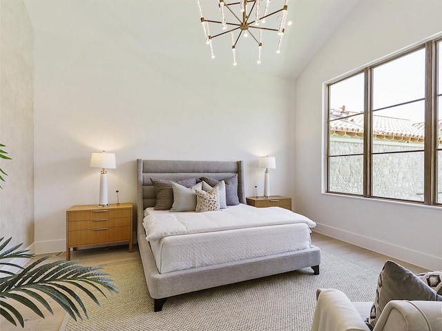 bedroom with vaulted ceiling and a chandelier