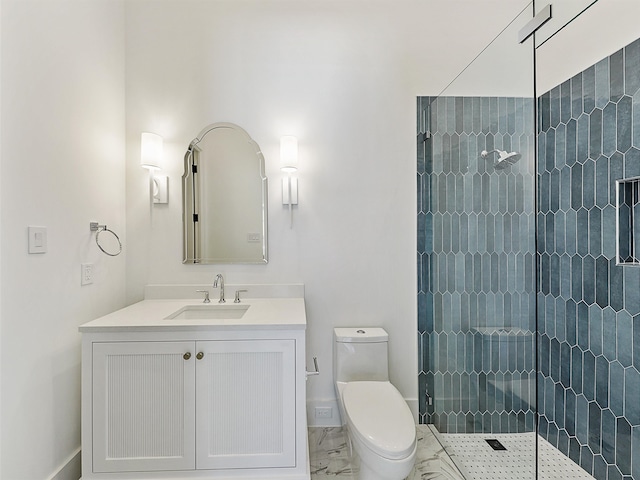 bathroom featuring tiled shower, vanity, and toilet