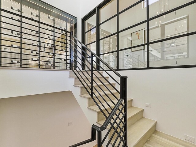 stairway featuring hardwood / wood-style floors and a wealth of natural light