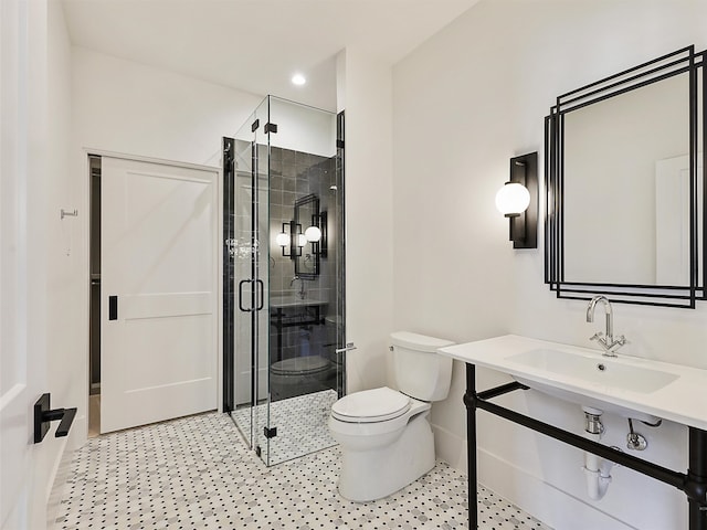 bathroom with walk in shower, sink, and toilet