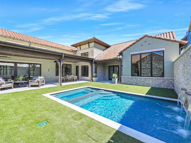 view of pool with ceiling fan, an outdoor living space, a yard, and a patio