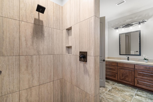 bathroom featuring walk in shower and vanity