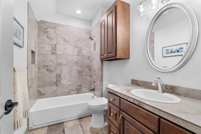 full bathroom with vanity, tiled shower / bath combo, and toilet