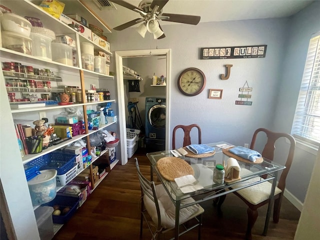 dining room with ceiling fan, washer / dryer, and dark wood-type flooring