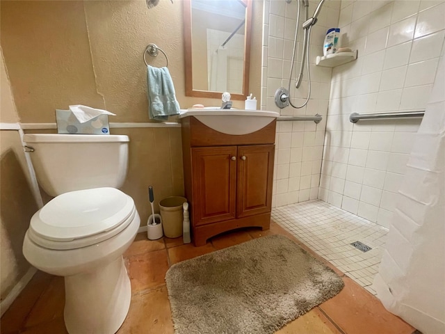 bathroom featuring a shower with curtain, tile floors, vanity with extensive cabinet space, and toilet