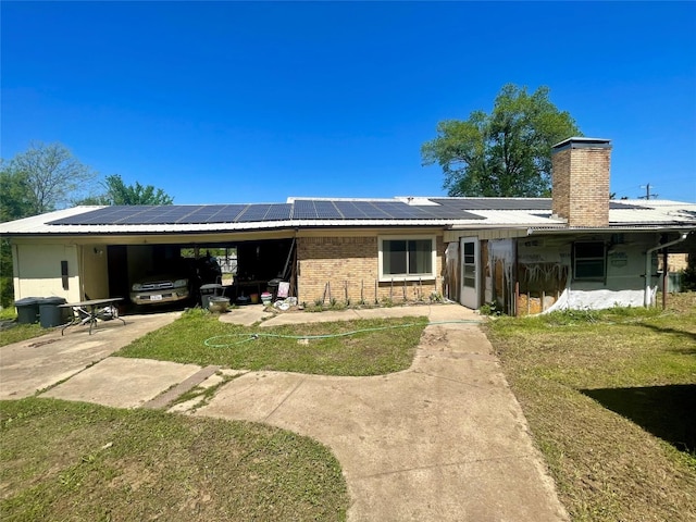 view of front of house with solar panels and a front yard