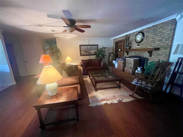 living room featuring brick wall, hardwood / wood-style floors, a brick fireplace, and ceiling fan