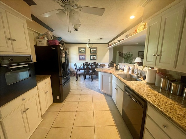 kitchen featuring ceiling fan, black appliances, sink, white cabinets, and light stone counters