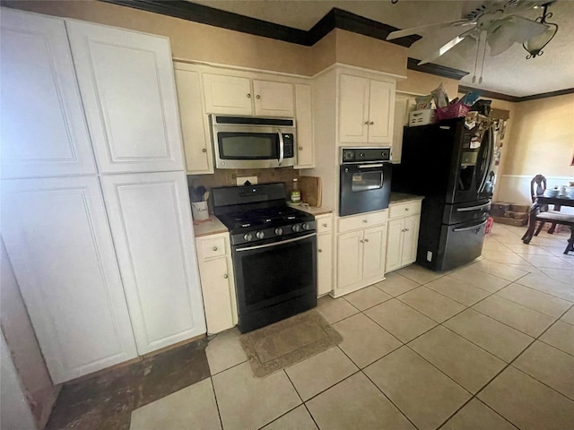 kitchen with ceiling fan, black appliances, light tile floors, white cabinets, and ornamental molding