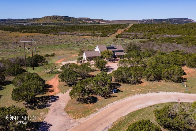 drone / aerial view featuring a mountain view and a rural view