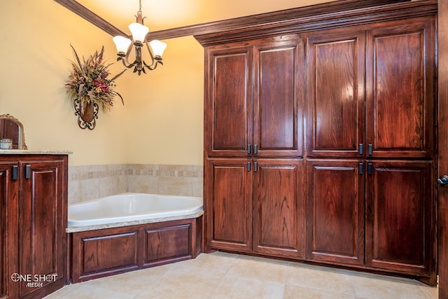 bathroom with a washtub, tile patterned flooring, a chandelier, and ornamental molding