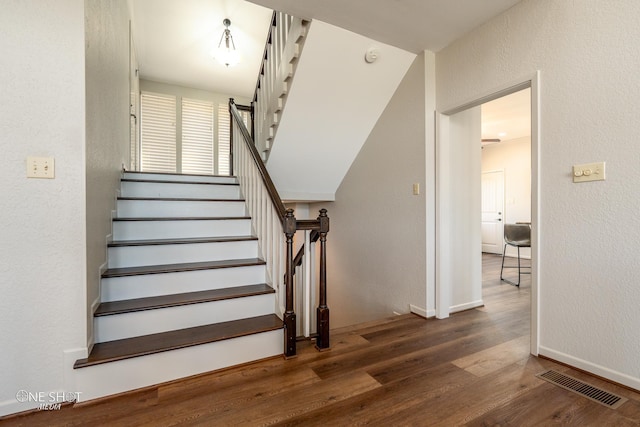 staircase featuring hardwood / wood-style floors