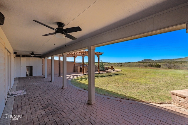 view of patio / terrace with a pergola, ceiling fan, and a mountain view