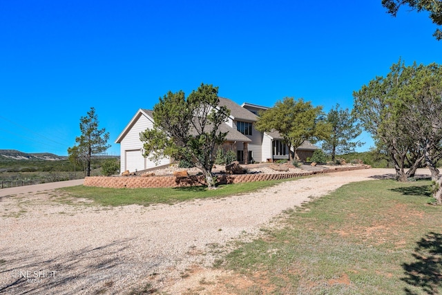 view of front of property with a front lawn and a garage